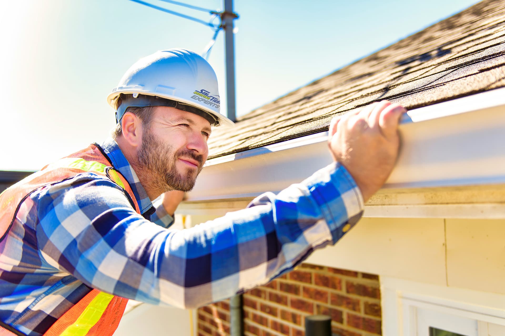 roofer inspecting shingle roof