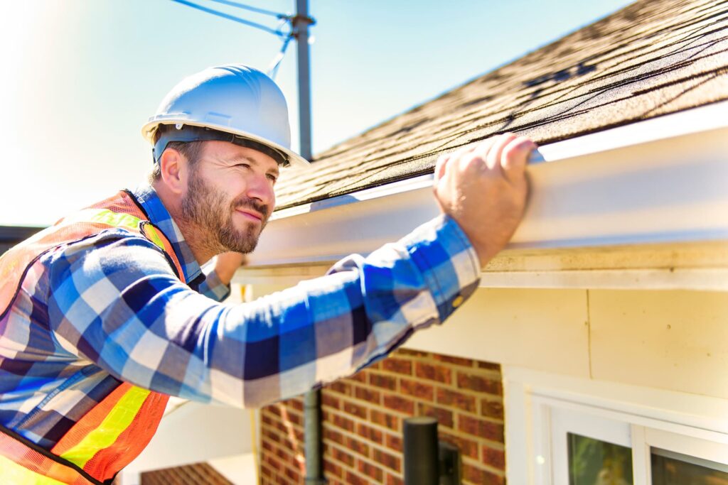 roofer inspecting shingle roof